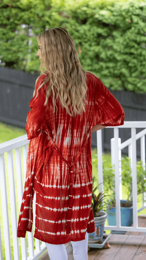 a woman in the porch wearing kimono-tie-dye-rust by Cienna Designs