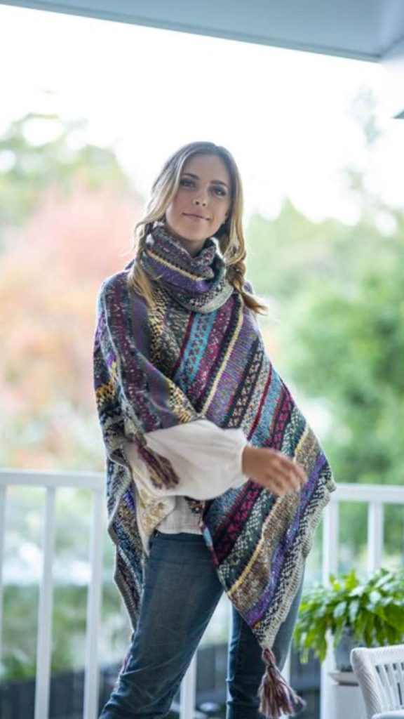 Mix roll neck poncho worn with weather and denim jeans bohemian style